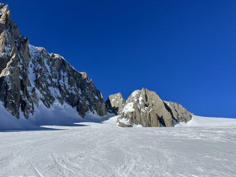 Traces de ski sur le glacier au pied des parois de granit